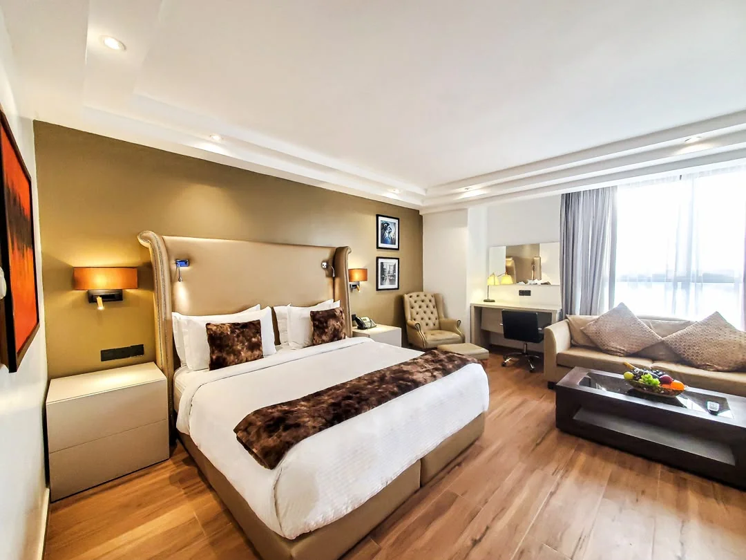 Bedroom with a wooden queen bed and soft neutral bedding